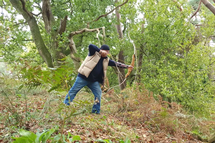 a man standing next to a tree