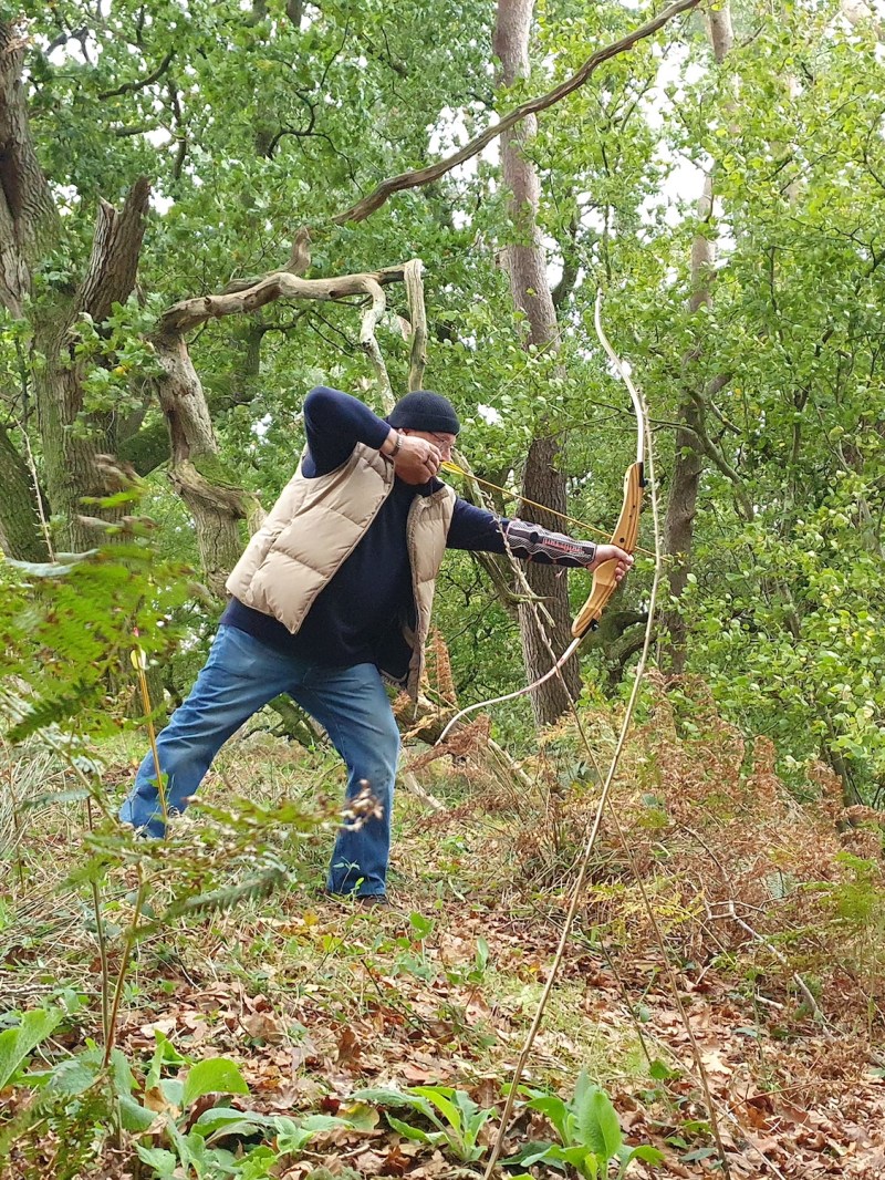 a man standing next to a tree